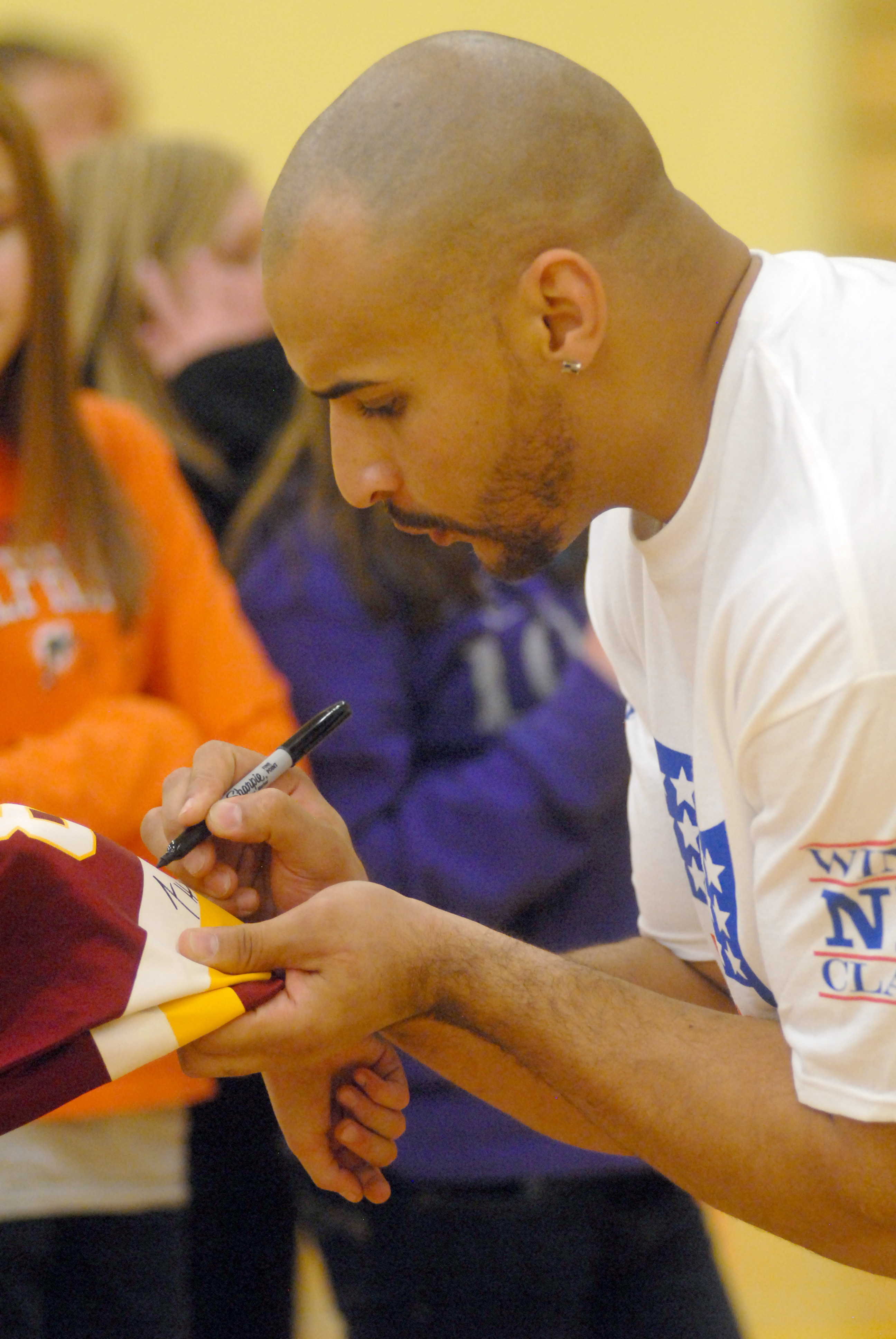 Former Flathead High School and University of Montana football player Lex Hilliard signs autographs during the Whitefish Winter Classic's NFL 60 Challenge in Whitefish. Hilliard is currently a running back for the Miami Dolphins. - Lido Vizzutti/Flathead Beacon