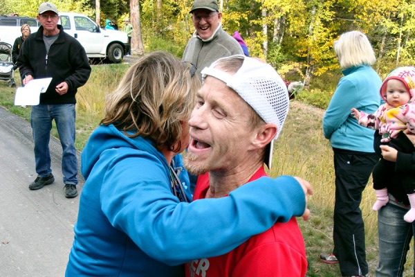 Course record-holder Mark Tarr is greeted by his wife Yvonne after completing his 20th Le Grizz. Courtesy Pat Caffrey