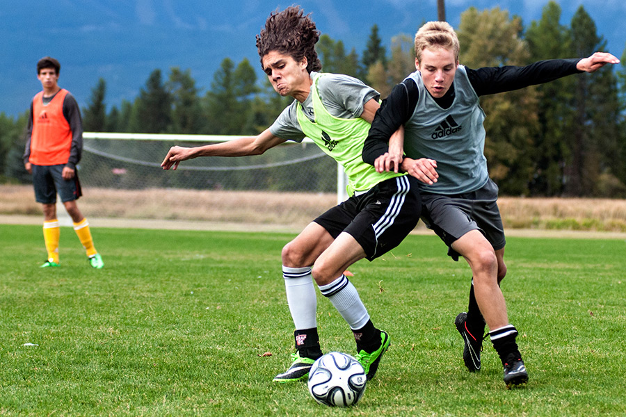 Captains Shanoah Montano, left, and Walter Sobba compete for the ball at Whitefish's soccer practice on Sept. 30, 2014. Greg Lindstrom | Flathead Beacon