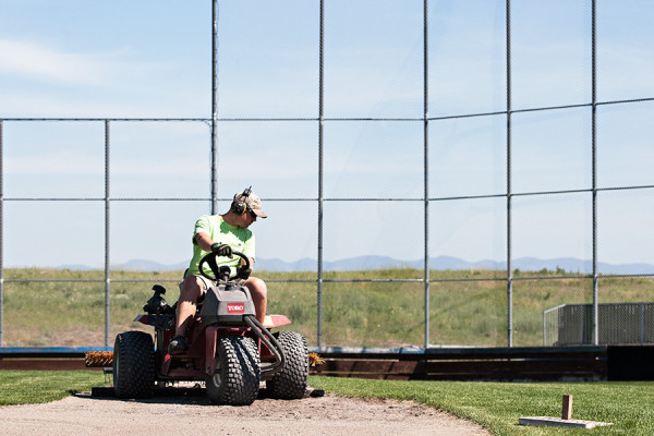 Brady Pelc, head caretaker at the Kidsports Complex in Kalispell, tends to a baseball field. Greg Lindstrom | Flathead Beacon