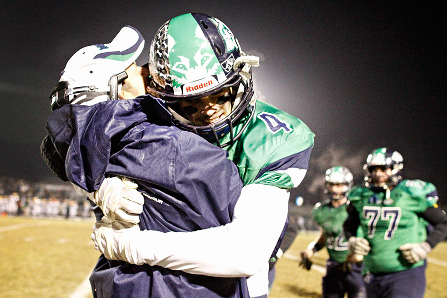 Head coach Grady Bennett lifts Thomas Trefney into the air after a touchdown run in the first half. Kalispell Glacier defeated Great Falls CMR 56-19 in the Class AA state championship game on Nov. 21, 2014. For more photos visit www.FlatheadBeacon.com. Greg Lindstrom | Flathead Beacon
