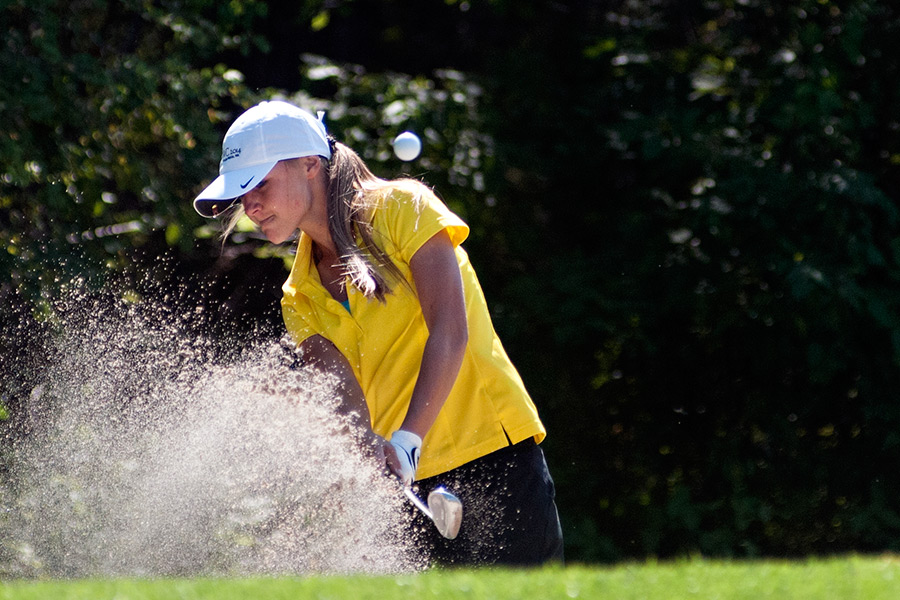 Whitefish's Coral Schulz hits out of the sand at Meadow Lake Golf Course on Sept. 16, 2014. Greg Lindstrom | Flathead Beacon