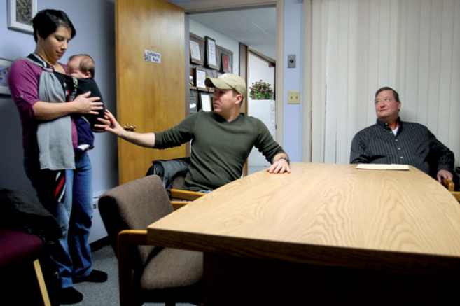 Iraq veteran Apollo Child, center, reaches for his son, Nathan, while talking about the difficulties of finding a job as his wife, Tamara Child, and Army veteran Dale Merrill, right, look on at the Flathead Job Service. - Lido Vizzutti/Flathead Beacon