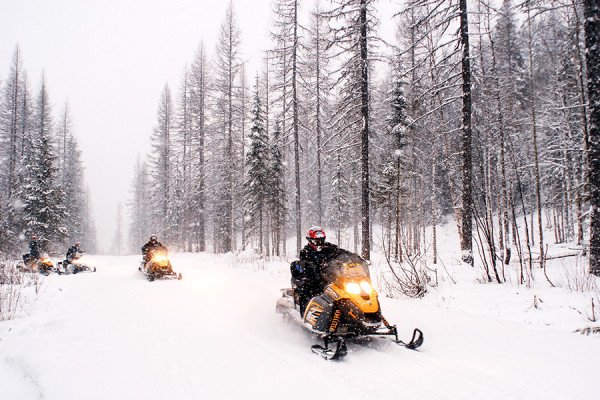 Snowmobilers begin their journey through the Flathead National Forest at the Canyon Creek Trail Head. Beacon File Photo