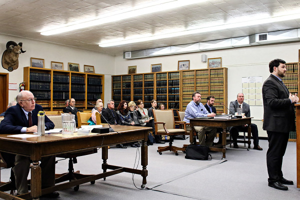 Sanders County Attorney Robert Zimmerman, left, Richard Raugust, in blue, and others listen to proceedings from Raugust's attorney Brett Schandelson, right. Raugust was released after a bail hearing in Sanders County District Court on Dec. 4, 2015. Raugust served more than 18 years in prison for the murder of his best friend, a crime he insists he didn't commit. Greg Lindstrom | Flathead Beacon