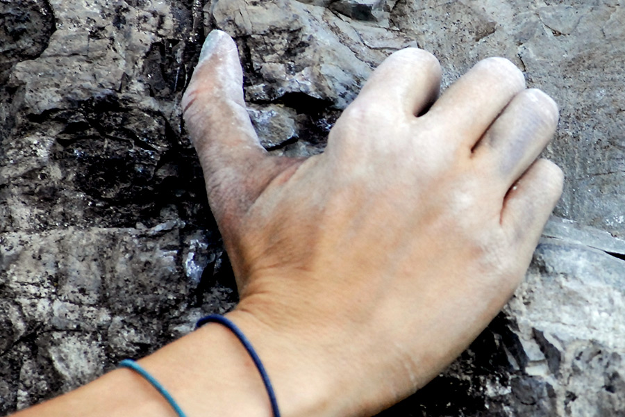 Chalked fingers find friction on the sedimentary rock while climbing Vertically Challenged, a 5.9 climb near Kila. Lido Vizzutti | Flathead Beacon