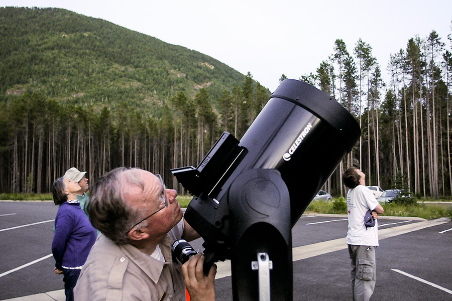 Dave Ingram, a volunteer with the International Dark-Sky Association, sets up his telescope before a summer astronomy program at the Apgar Transit Center in Glacier National Park. Lido Vizzutti | Flathead Beacon