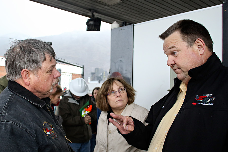 U.S. Sen. Jon Tester, right, speaks with Columbia Falls mayor Don Barnhart, left, and city manager Susan Nicosia after a tour of the Columbia Falls Aluminum Company site. Beacon File Photo
