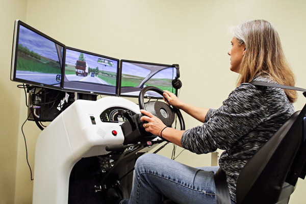 Denise Zander, an occupational therapist at The Summit in Kalispell, demonstrates a new driving simulator on May 13, 2016. Greg Lindstrom | Flathead Beacon