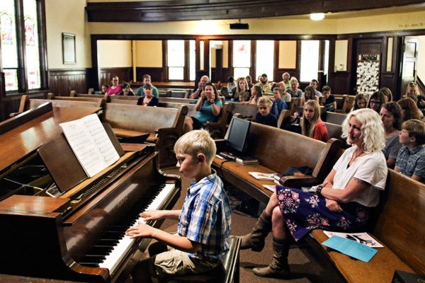 North Valley Music School instructor Tina Bertram watches as Isaac Gibbs performs during a recital on May 18, 2016. Greg Lindstrom | Flathead Beacon