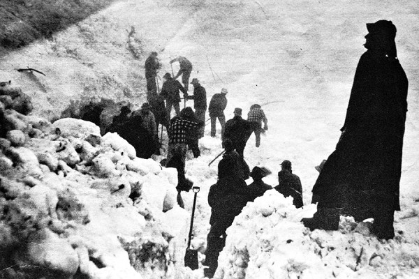 Workers dig around a hole where Jean Sullivan was found during a May 1953 avalanche rescue operation along Going-to-the-Sun Road between the Loop and Logan Pass. Courtesy Glacier National Park