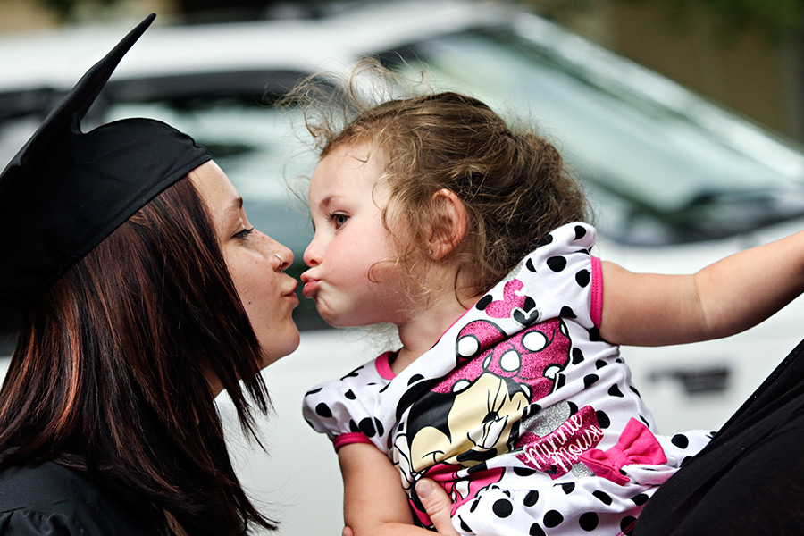 Arisa O'Lexey gets a kiss from her daughter, Lillyandra, after Linderman Education Center's graduation on June 2, 2016. Greg Lindstrom | Flathead Beacon