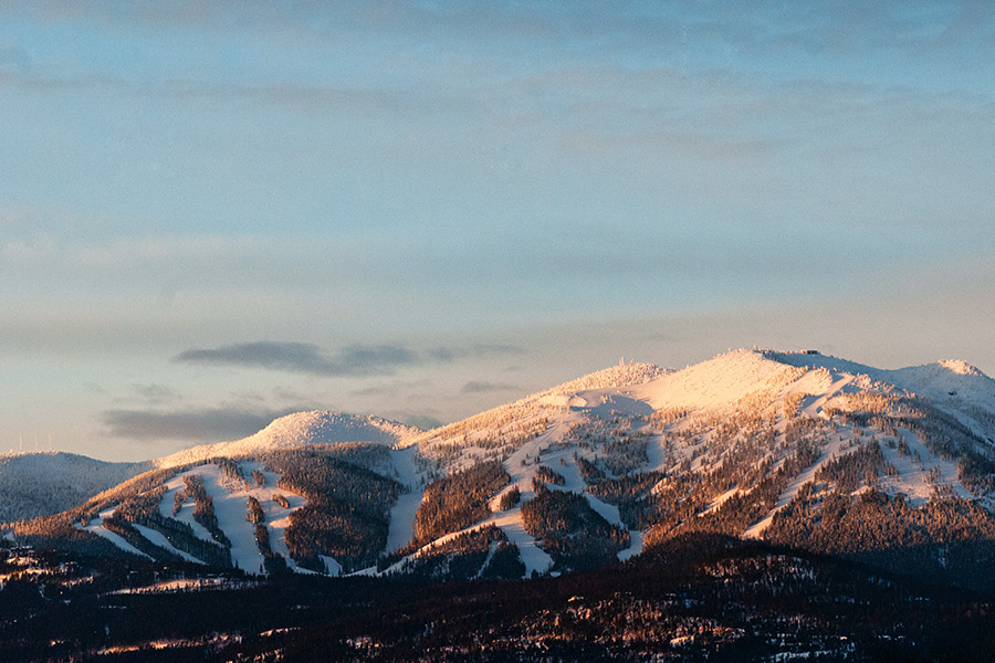 The setting sun illuminates Big Mountain and the runs of Whitefish Mountain Resort. Beacon File Photo