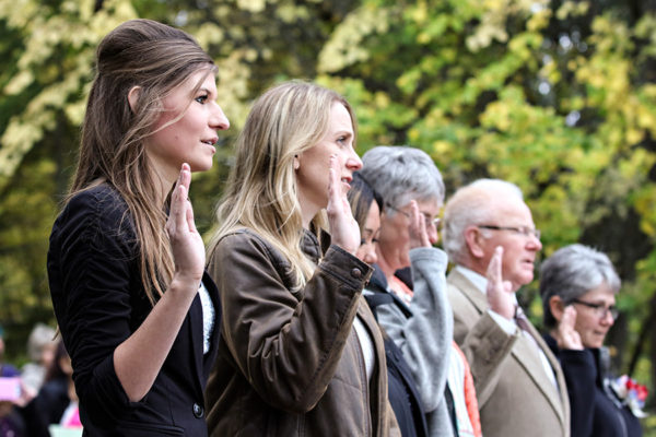 Olga Bobko, left, recites the Naturalization Oath during a ceremony at the Apgar amphitheater in Glacier National Park on Sept. 21, 2016. Greg Lindstrom | Flathead Beacon