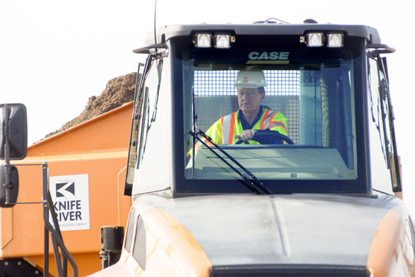 U.S. Senator Max Baucus backs a rock truck into position to unload its contents at a construction site on U.S. Highway 93 north of Kalispell. The senator spent a full 8-hour day doing construction as one of his signature "work days" in 2009. Beacon File Photo