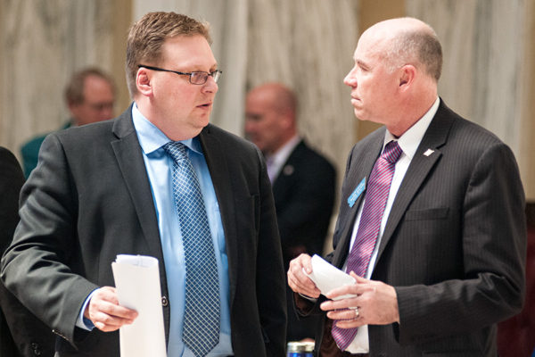 Sen. Mark Blasdel talks to Rep. Mark Noland during the 64th Montana Legislative Session in Helena on April 23, 2015. Greg Lindstrom | Flathead Beacon
