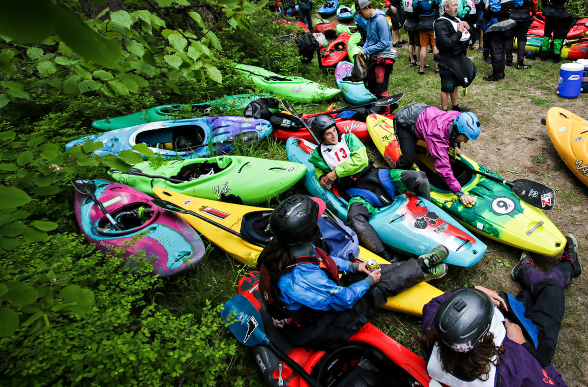 Kayakers gather on the bank near the Wild Mile