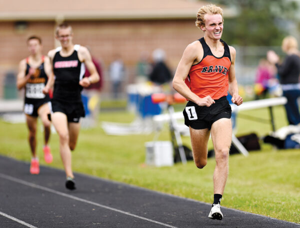A runner in an orange singlet with 